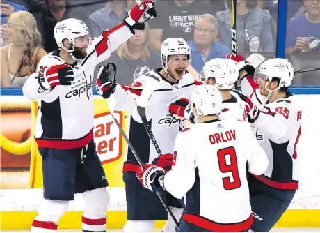  ?? MIKE CARLSON/GETTY IMAGES ?? Jay Beagle, centre, and his Washington Capitals teammates were all smiles Friday at Amalie Arena in Tampa, Fla., as the Metropolit­an Division champs won 4-2 to take a 1-0 series lead over the Tampa Bay Lightning in the Eastern Conference final. Game 2...