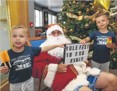  ?? Picture: John Westhrop FM4890037 ?? ‘Santa’ Ben Hughes poses with John Smith, four, left, and his brother, Rocky, five, at the Village Hotel’s Yule Fest during the launch of their Christmas parties