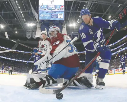  ?? BRUCE BENNETT/ GETTY IMAGES ?? Corey Perry of the Tampa Bay Lightning scores against Pavel Francouz of the Colorado Avalanche during the second period of Game 3 of the Stanley Cup Final at Amalie Arena in Tampa, Fla., Monday night. The Bolts won the game 6-2.