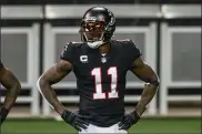  ?? DANNY KARNIK — THE ASSOCIATED PRESS FILE ?? In this Sunday, Dec. 6, 2020, file photo, Atlanta Falcons wide receiver Julio Jones (11) warms up before an NFL football game against the New Orleans Saints in Atlanta. The Tennessee Titans have traded with the Atlanta Falcons for seven-time Pro Bowl wide receiver Julio Jones, a person familiar with the situation told The Associated Press.