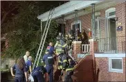  ??  ?? Firefighte­rs remove the first victim from an early morning fire Monday on East Fifth Street in Pottstown.