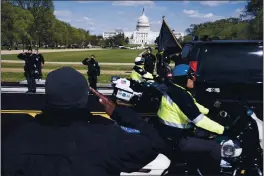  ?? JOSE LUIS MAGANA — THE ASSOCIATED PRESS ?? With the U.S. Capitol in the background, U.S. Capitol Police officers salute as procession carries the remains of a U.S. Capitol Police officer who was killed after a man rammed a car into two officers at a barricade outside the Capitol in Washington, Friday.