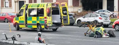  ?? PHOTO: STEPHEN JAQUIERY ?? At the scene . . . Emergency services attend to a cyclist who was hit by a car yesterday morning.