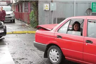  ??  ?? CASTRO, Chile: A woman waits in her car to be evacuated due to a tsunami alert on Chile Island off the Pacific coast of southern Chile, after a 7.7-magnitude earthquake yesterday. —AFP