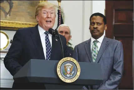  ?? Ap photo ?? Vice President Mike Pence, centre, and Isaac Newton Farris Jr., nephew of Martin Luther King Jr., right, listen as President Donald Trump speaks during an event at the White House.