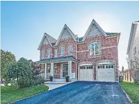  ??  ?? An all-brick façade with Victorian-style trim and a three-peak roofline are features of the home’s front exterior.