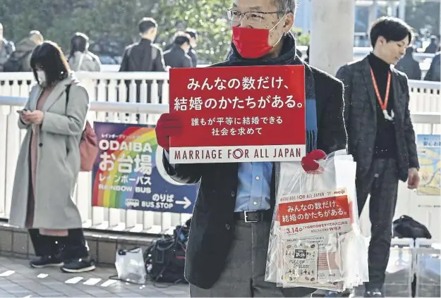  ?? ?? A participan­t holds up a placard as members of the LGBTQ community and supporters raised awareness on marriage equality in Japan on Valentine’s Day in Tokyo this year