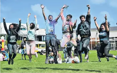  ??  ?? A break from study . . . PhD students (from left) Zahra Rahmani, Mitra Darestani, Zohaib Amjad, Amir Amini, Parham Hosseini and Golnoush Madani jump for joy at the Rainbow Run at Logan Park, Dunedin, yesterday.