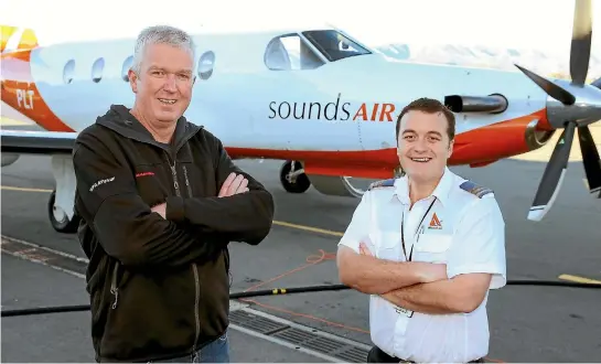  ?? PHOTO: DEREK FLYNN/FAIRFAX NZ ?? Sounds Air managing director Andrew Crawford, left, and senior pilot Tim Johnson with a Pilatus PC-12.