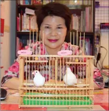  ?? STEVE MacNAULL/The Okanagan Weekend ?? Fortune teller Miss Chen uses birds to help tell peoples’ fortunes in a tiny cubicle near Longshan Temple.