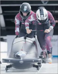  ?? — THE CANADIAN PRESS ?? Canada’s Kaillie Humphries and Melissa Lotholz take off on their first bobsled run at the World Cup in Whistler Saturday.