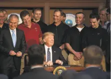  ?? Stephen Crowley / New York Times ?? President Trump signs an order on climate change policies in Washington alongside EPA chief Scott Pruitt (left) in March.