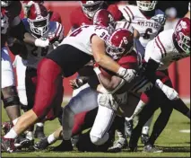  ?? Associated Press ?? New Mexico State defensive lineman Garrett Bishop (96) tackles Alabama running back Trey Sanders (6) during the second half of an NCAA college football game on Saturday in Tuscaloosa, Ala.