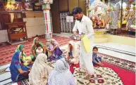  ?? AFP ?? Pakistani Hindus pray at the Shri Krishna Temple in Mithi — a city renowned for its low crime rate.