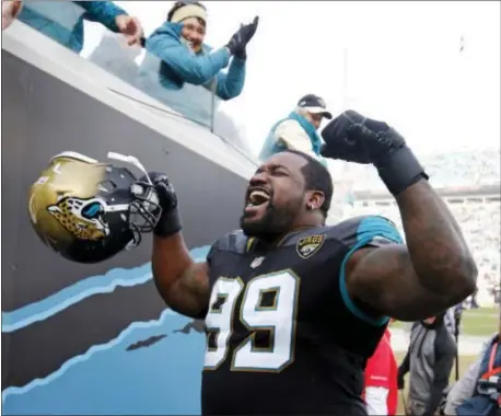  ?? STEPHEN B. MORTON — THE ASSOCIATED PRESS ?? Jacksonvil­le Jaguars defensive tackle Marcell Dareus (99) flexes as he celebrates after defeating the Buffalo Bills in an NFL wild-card playoff football game, Sunday in Jacksonvil­le, Fla.