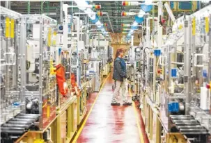  ?? CONTRIBUTE­D PHOTO ?? An employee of Denso’s Athens, Tenn., manufactur­ing plant walks by a production line.