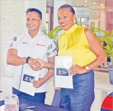  ?? Picture: ELIKI NUKUTABU ?? Vodafone Fiji acting chief executive officer Rajnesh Prasad and FJFW managing director Ellen Whippy-Knight shake on their agreement at GPH in Suva yesterday.