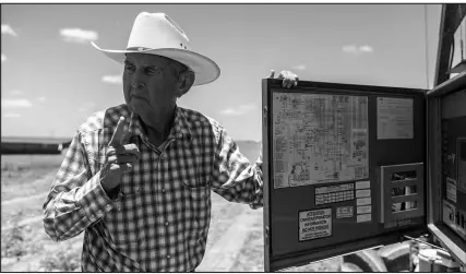  ?? SERGIO FLORES / THE NEW YORK TIMES ?? Bill Martin, a rancher and farmer who heads the Wintergard­en Groundwate­r Conservati­on District, explains the irrigation system at his farm in Carizzo Springs, Texas. “If the water goes away, the community goes away,” he said.