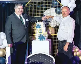  ?? ?? Current board chair Rob Bruce and long-serving past board chair John Ballantyne cut the cake at Chairo’s 40-year celebratio­n dinner.