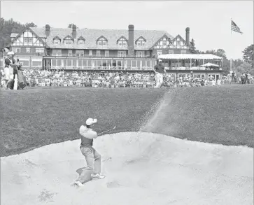  ?? Stuart Franklin Getty Images ?? DEFENDING CHAMPION Jason Day plays a shot out of bunker on the 18th hole at Baltusrol. He shot a 68.