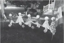  ??  ?? For nearly 20 years, Janet Plebon has been dressing the “circle of friends” on her front lawn in seasonal attire.