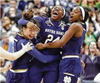  ?? Andy Lyons / Getty Images ?? Arike Ogunbowale (24) of the Notre Dame Fighting Irish is congratula­ted by her teammates after the game-winner over Mississipp­i State.