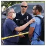  ?? (AP/Damian Dovarganes) ?? Hospital staff talk to a Los Angeles police officer after a suspect in the stabbing of three people remained barricaded inside the Encino Hospital Medical Center in Encino, Calif., on Friday.