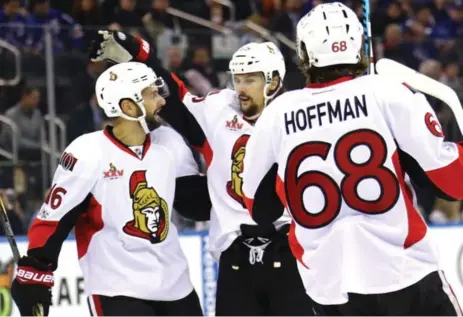  ?? BRUCE BENNETT/GETTY IMAGES ?? The Senators’ Clarke MacArthur, left, Erik Karlsson and Mike Hoffman celebrate after collaborat­ing on their team’s first goal against the New York Rangers on Tuesday. With the series win, Ottawa is off to the Eastern Conference final for the first time...