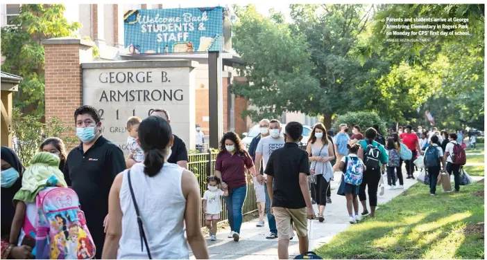  ?? ASHLEE REZIN/SUN-TIMES ?? Parents and students arrive at George Armstrong Elementary in Rogers Park on Monday for CPS’ first day of school.