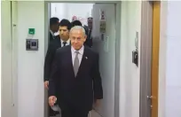  ?? (Moti Milrod/Pool/Flash90) ?? PRIME MINISTER Benjamin Netanyahu and his wife, Sara, arrive to testify in the lawsuit filed by attorney David Shimron against attorney David Artzi, at the court in Rishon Lezion yesterday.