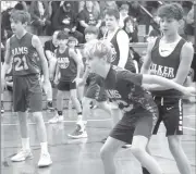  ?? Photo by Bob Parana ?? Johnsonbur­g’s Cooper Pura boxes out Ridgway’s Liam Kilpeck during the Rams 41-25 sixth-grade win on Saturday at FSG Elementary School.