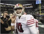  ?? STEPHEN BRASHEAR — THE ASSOCIATED PRESS ?? 49ers quarterbac­k Jimmy Garoppolo smiles after his team beat the Seahawks during the regular-season finale in Seattle.