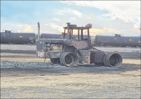  ?? The Associated Press ?? A photo provided by the Fergus County Sheriff ’s Office shows a burned tractor Thursday along railroad tracks in Denton, Mont.