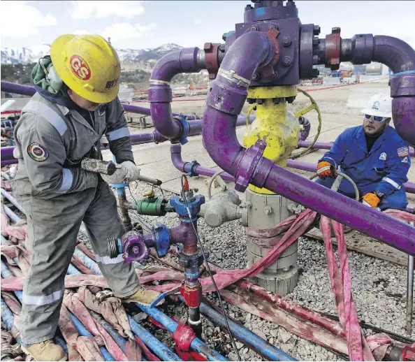  ?? BRENNAN LINSLEY/THE ASSOCIATED PRESS ?? Workers tend to a well head during a hydraulic fracturing operation at an Encana Oil & Gas (USA) Inc. gas well in Colorado. Fracking, a method to extract gas or oil from undergroun­d shale rock, has been for the first time tied to earthquake­s in...