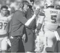  ?? JOE RONDONE/THE REPUBLIC ?? ASU interim head coach Shaun Aguano addresses players during Saturday’s game against Oregon State at Sun Devil Stadium.