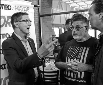  ?? EDUARDO MUNOZ ALVAREZ / ASSOCIATED PRESS ?? Michael Flynn, left, former national security adviser to former President Donald Trump, speaks June 3 with attendees at the end of a campaign event in Staten Island, N.Y., where he endorsed New York City mayoral candidate Fernando Mateo.