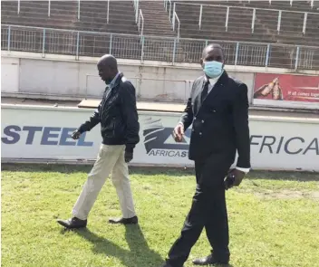  ??  ?? FOR PERFECTION . . . Musa Gwasira (right) assesses progress on the Rufaro turf in the company of Harare City ZIFA” Chiyangwa during a tour of the stadium last week