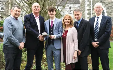  ?? Photo by Michelle Cooper Galvin ?? CEO Monex Financial Services Frank Murphy presenting the Monex Scholarshi­p UCC Award to winner Andrew Quinlivan from Killarney with (left) teacher Mike Leahy; parents Clare and Con Quinlivan; and Principal Sean Coffey at St Brendan’s College, Killarney.