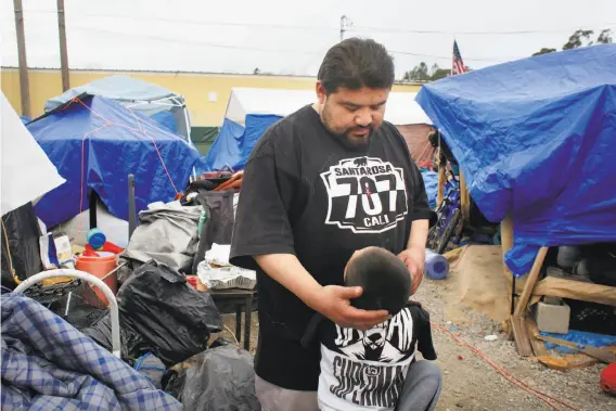  ?? Lea Suzuki / The Chronicle ?? Top: Keith Faber and son King, 3, talk outside their tents at a homeless camp in Santa Rosa. They’ve since moved to a shelter.