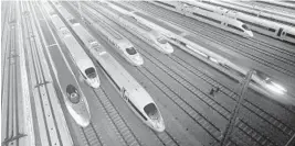  ?? AP FILE PHOTO ?? High-speed trains sit at a maintenanc­e base in Wuhan, in the Hubei province. China has connected its major cities, and is moving to secondary and tertiary cities, Friedman says.