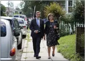  ?? MARY SCHWALM — THE ASSOCIATED PRESS ?? Dan Sideris and his wife, Carrie Sideris, of Newton, Mass., walk along a sidewalk in Boston as they return to door-to-door visits as Jehovah’s Witnesses on Thursday.