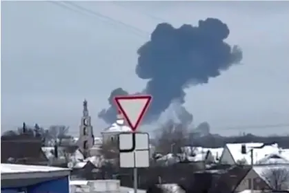  ?? Photograph: AP ?? In this photo taken from validated UGC video, smoke rises from the scene of a plane crash in a residentia­l area near Yablonovo, Belgorod region.