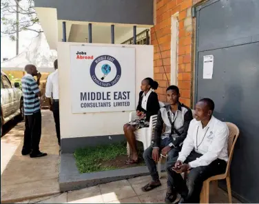  ??  ?? Outside Middle East Consultant­s, where people come every day to apply for jobs abroad and check for vacancies