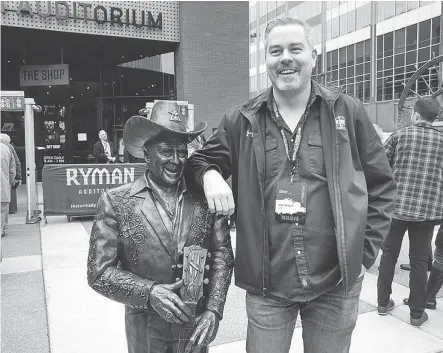  ??  ?? FACEBOOK PHOTO Grant Biebrick poses with the statue of Little Jimmy Dickens outside the Ryman Auditorium in Nashville.