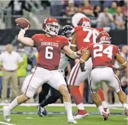  ?? ASSOCIATED PRESS FILE PHOTO ?? Oklahoma and quarterbac­k Baker Mayfield, front, will face Georgia on Jan. 1 in the Rose Bowl in Pasadena, Calif.