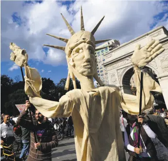  ?? Emmanuel Dunand / AFP / Getty Images 2011 ?? Occupy Wall Street participan­ts protest in New York in October 2011 after the financial crisis took away young adults’ ability to pay off the debt they took on.