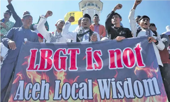  ??  ?? Anti-LGBT protest in Banda Aceh. Police say the re-education training is to protect transgende­r people from conservati­ve organisati­ons.