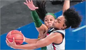  ?? MORRY GASH/AP PHOTO ?? UConn’s Christyn Williams, right, is defended by Baylor’s Sarah Andrews during Monday night’s NCAA Elite Eight game at the Alamodome in San Antonio.