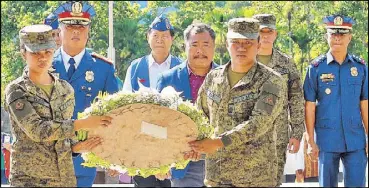  ?? VICTOR MARTIN ?? PNP Directoria­l Staff secretary Brig. Gen. Jesus Cambay Jr. and Ifugao Gov. Gerry Dalipog lead the wreath-laying rites in Barangay Linda Kiangan for the 74th anniversar­y of the surrender of Japanese wartime general Tomoyuki Yamashita yesterday.