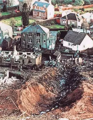  ?? MARTIN CLEAVER/AP FILE ?? This December 1988 file photo shows wrecked houses and a deep gash in the ground in the village of Lockerbie, Scotland, that was caused by the crash of Pan Am Flight 103. In 1988, 270 people were killed when a terrorist bomb exploded aboard a Pam Am Boeing 747 over Lockerbie, Scotland, sending wreckage crashing to the ground.